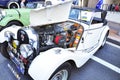 White Morgan Vintage car opens the hood showing its engine at Classic motor show on Australia day.